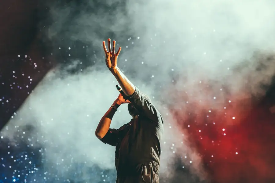 Performer on stage in red and blue light