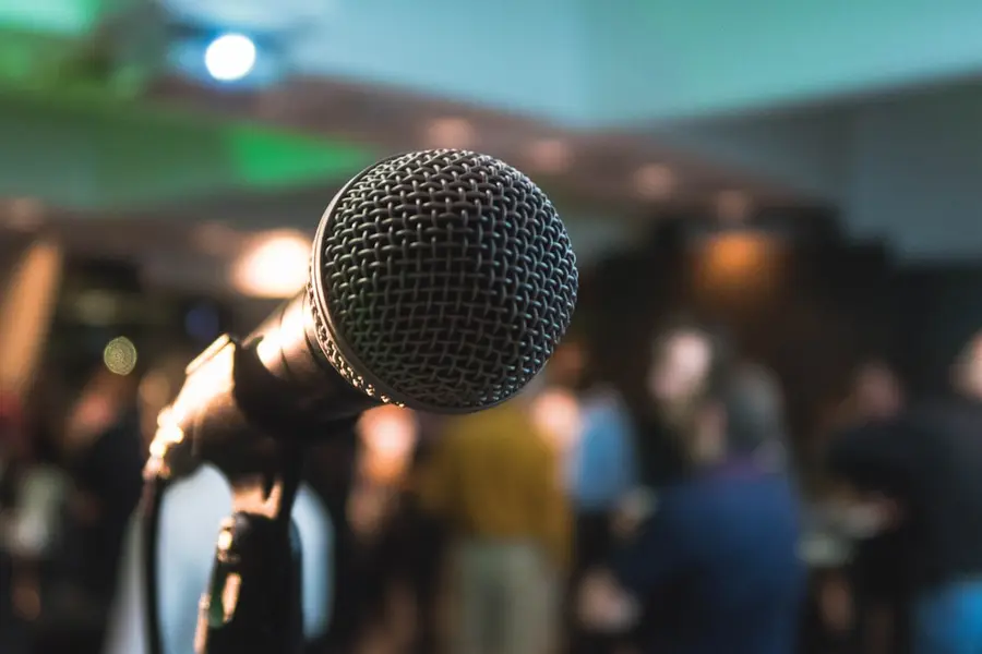 Stage microphone in front of a blurred audience